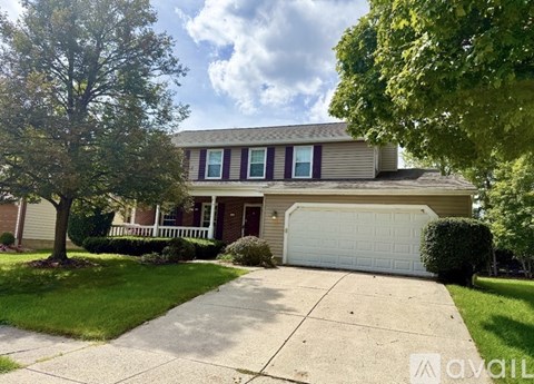 A house with a white garage door is for sale.
