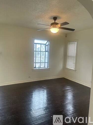 A room with a ceiling fan and a window.