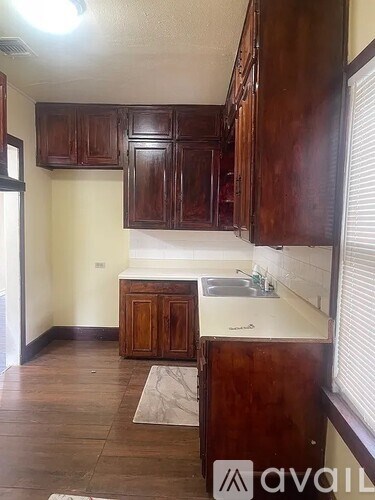 A kitchen with wooden cabinets and a sink.