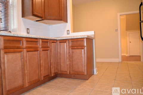 A kitchen with wooden cabinets and a white countertop.