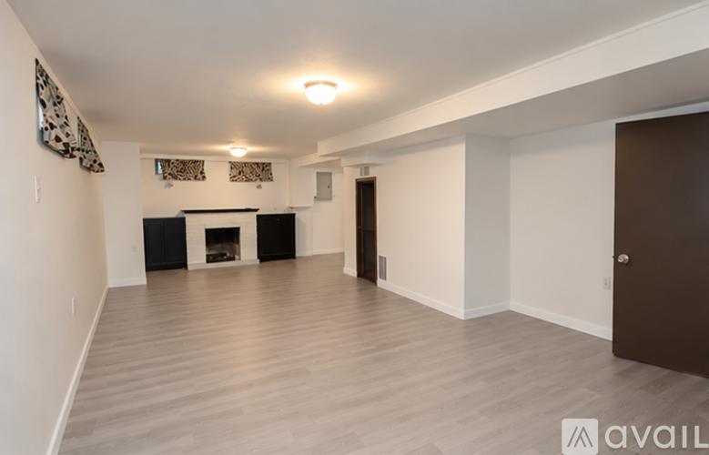 A spacious living room with a fireplace and hardwood floors.