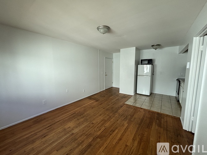 A room with wooden floors and white walls.