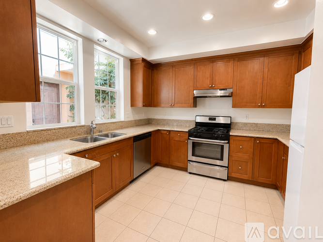 A kitchen with wooden cabinets and a granite countertop.