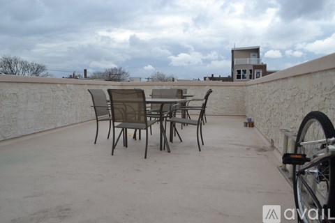 A patio with a table and chairs and a bicycle.