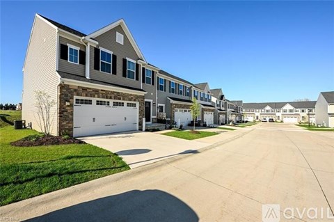 A row of houses with a clear blue sky above them.