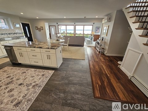 A spacious kitchen with a large island and a dining area with a table and chairs.