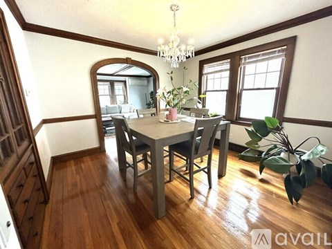 A dining room with a wooden table and chairs.