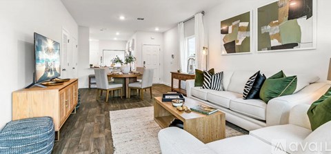 A living room with a white couch and a wooden coffee table.