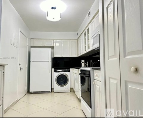 A kitchen with white appliances and cabinets.
