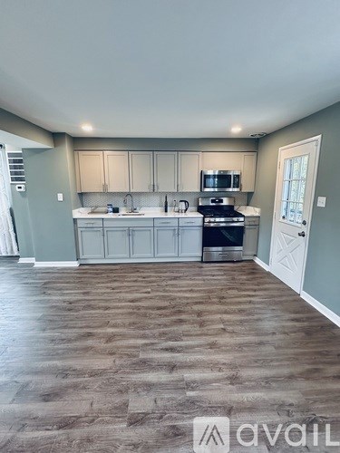 A kitchen with a stove top oven and a microwave built into the cabinetry.
