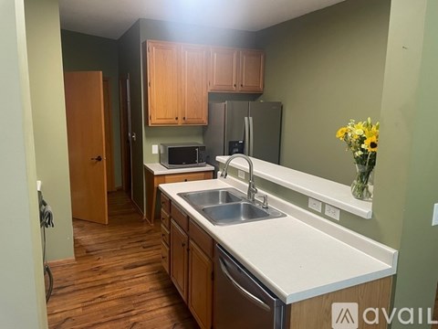 A kitchen with wooden cabinets and a white countertop.