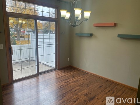 A room with wooden floors and a chandelier.