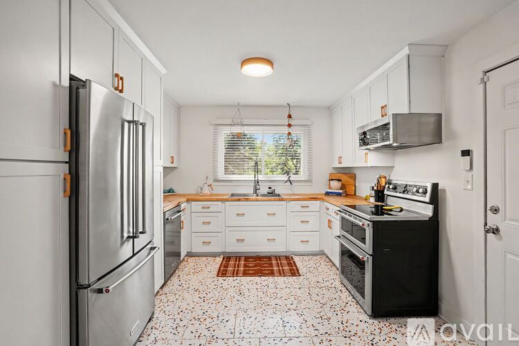 A kitchen with a refrigerator, stove, and oven.