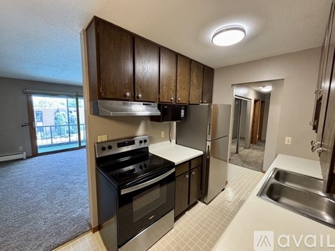 A kitchen with a black stove top oven and a sink.