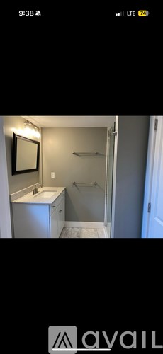 A bathroom with a sink, mirror, and bathtub.