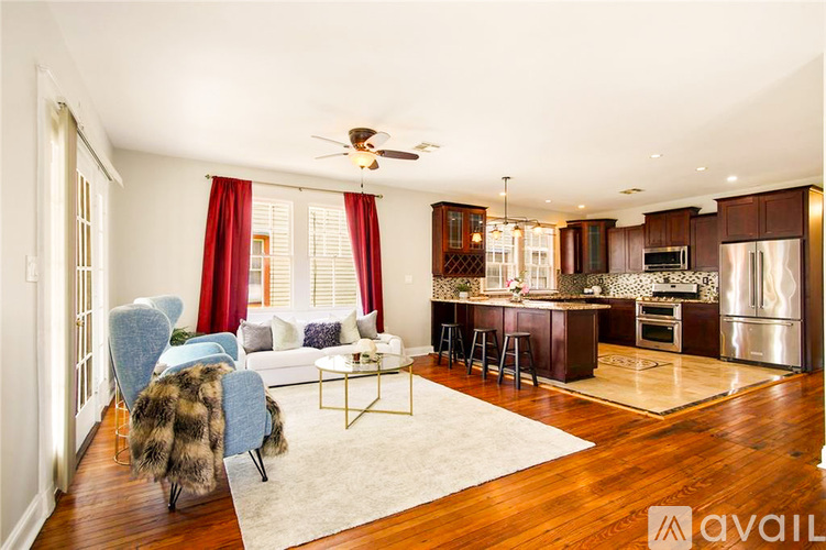 A modern kitchen with a dining area and a living room.