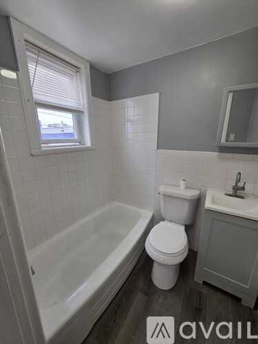 A bathroom with a toilet, sink, and bathtub.