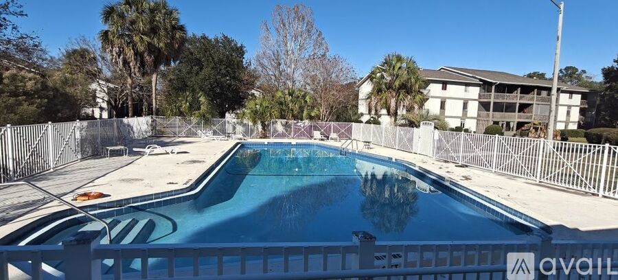 A pool surrounded by a fence with the word "AVAILABLE" written on it.