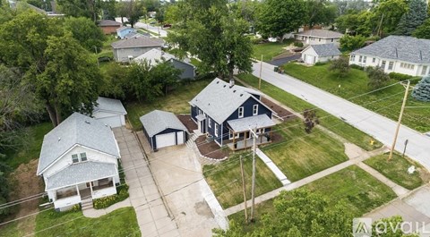 A bird's eye view of a residential area with houses and trees.