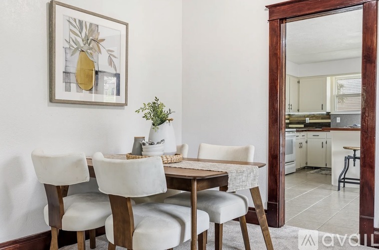 A dining room with a table set for four.