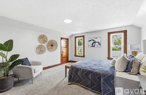 A bedroom with a large bed and a couch.