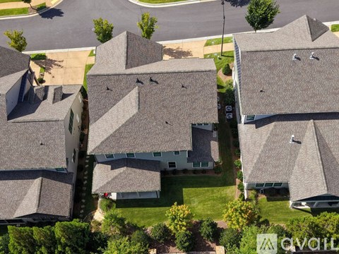 A bird's eye view of a neighborhood with houses and trees.