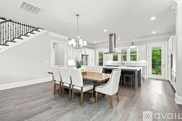 A modern kitchen with a dining table and chairs.