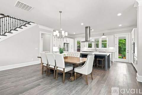 A modern kitchen with a dining table and chairs.