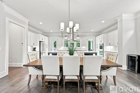 A dining room with a wooden table and chairs.