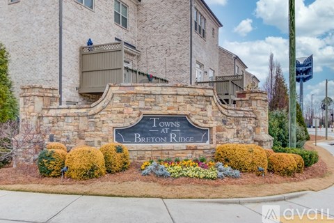 A sign that says Towns at Breton Ridge in front of a building.