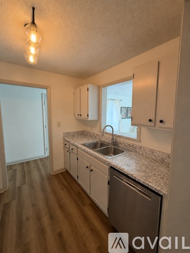 A kitchen with a sink and cabinets.