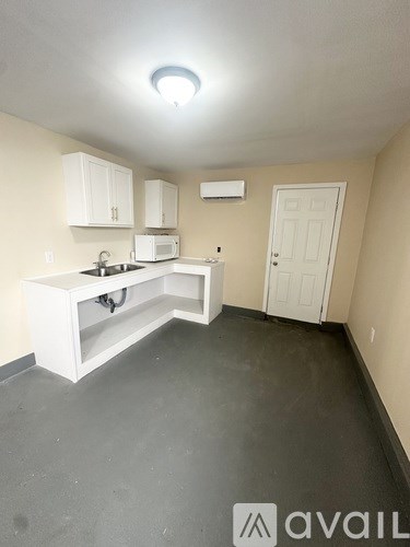 A kitchen with white cabinets and a sink.