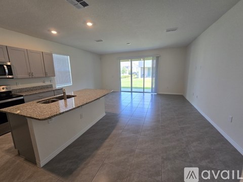 A kitchen with granite countertops and stainless steel appliances.