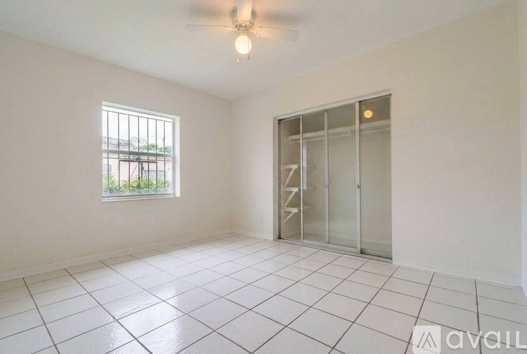 A room with a window and a sliding door is available for rent.