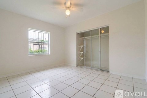 A room with a window and a sliding door is available for rent.