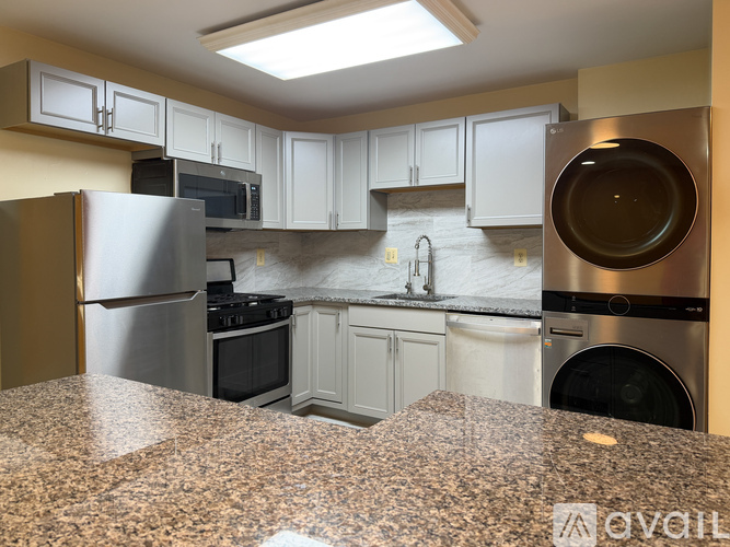 A kitchen with granite countertops and stainless steel appliances.