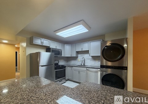 A kitchen with granite countertops and stainless steel appliances.