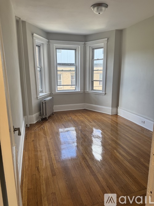 A room with wooden floors and white walls.