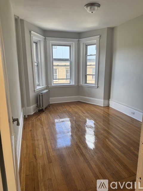 A room with wooden floors and white walls.