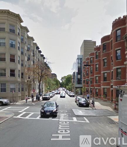 A street view with cars and buildings on both sides.