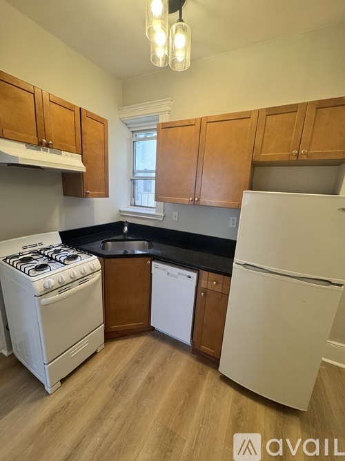 A kitchen with wooden cabinets and a white stove.