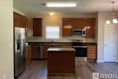 A kitchen with wooden cabinets and stainless steel appliances.