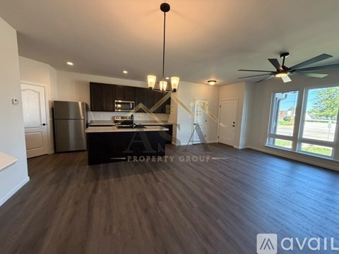 A spacious kitchen with a refrigerator, stove, and sink is available for rent.