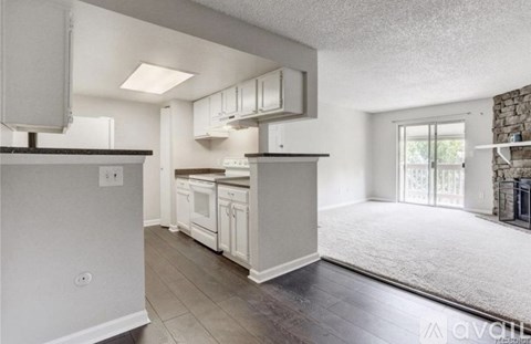 A kitchen with white appliances and a large island.
