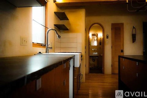 A kitchen with wooden cabinets and a dark countertop.