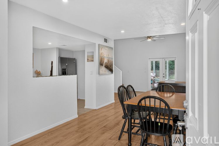 A dining room with a wooden table and chairs.