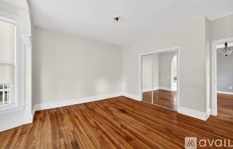 A room with wooden floors and white walls.