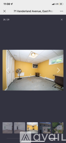 A room with yellow walls and a grey floor.