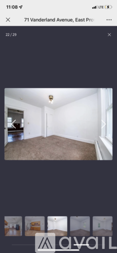 A room with a carpeted floor and a white ceiling.