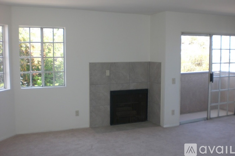 A room with a fireplace and a window.